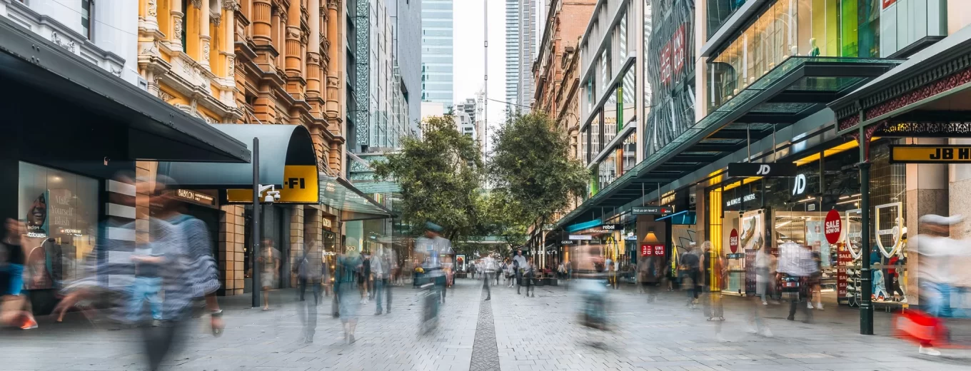 People walking through cityscape
