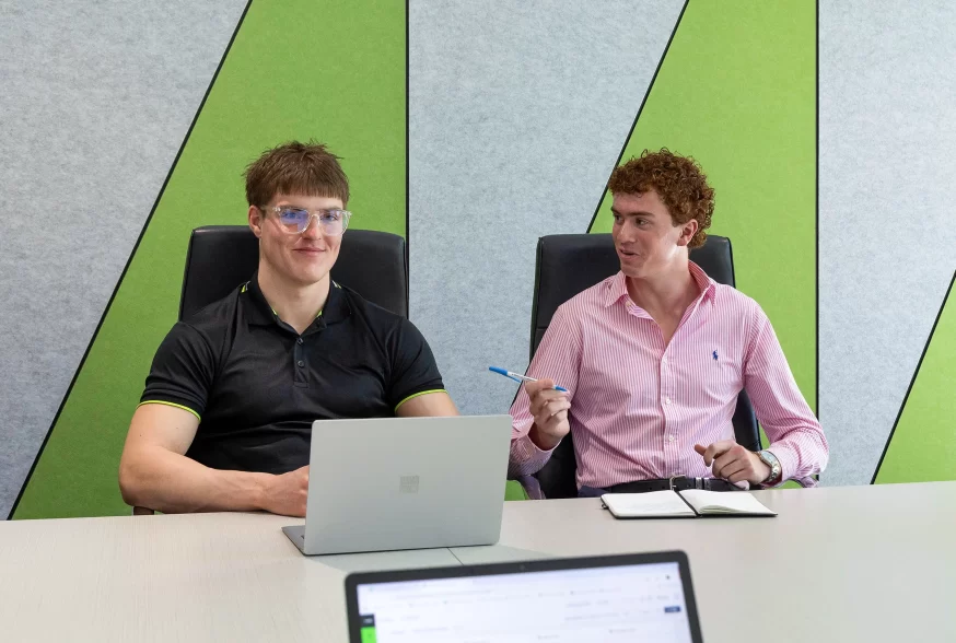 Two strata trainees sitting togetherin a meeting